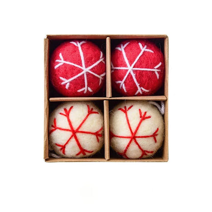 Four red and white textured Christmas balls in a box 