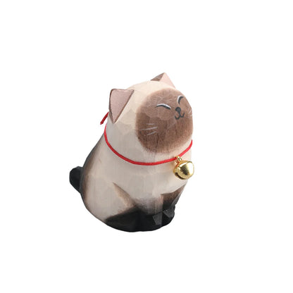 Cat-shaped figurine with a red collar and gold bell on a white background