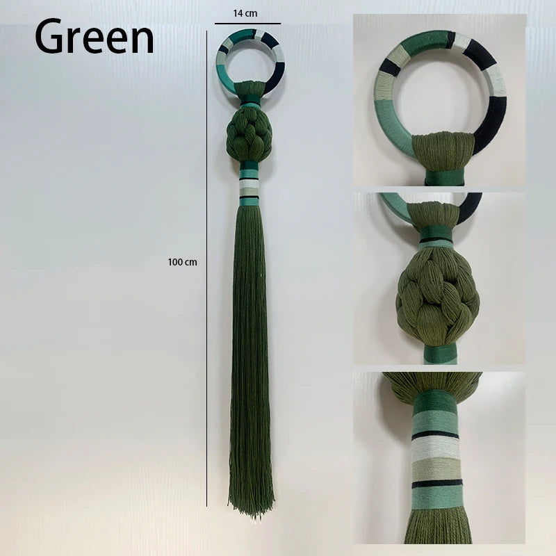 Green decorative item with tassel and measurement details on a white background. boho macrame wall art