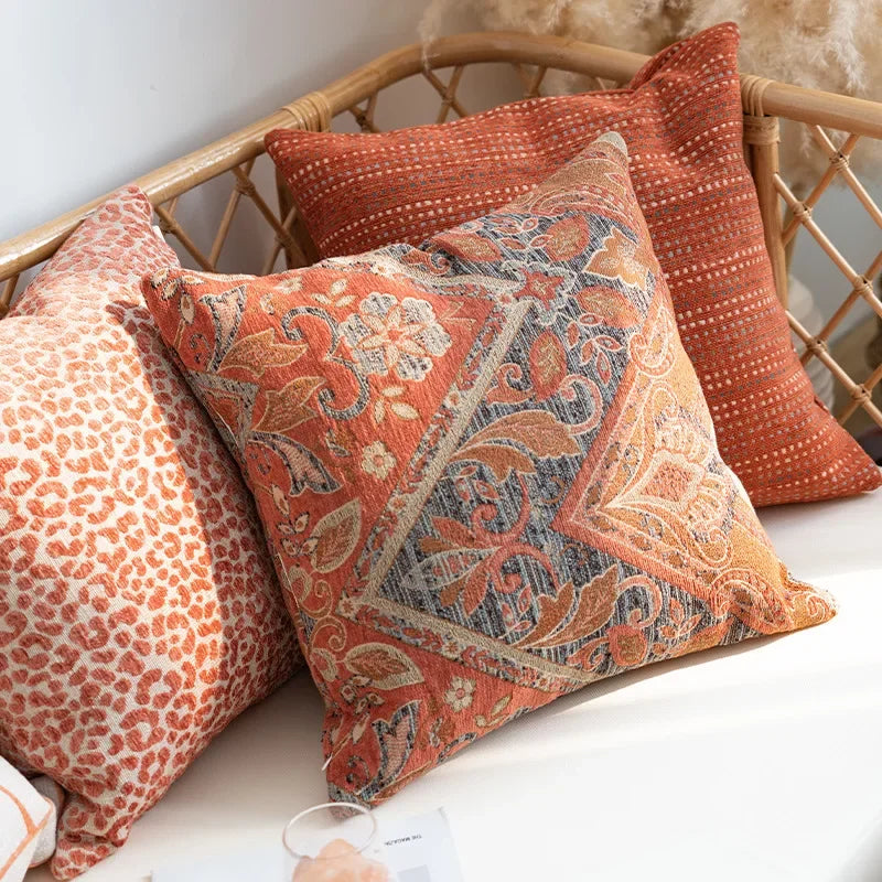Decorative pillows with paisley pattern on a wicker chair