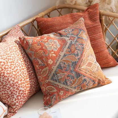 Decorative pillows with paisley pattern on a wicker chair