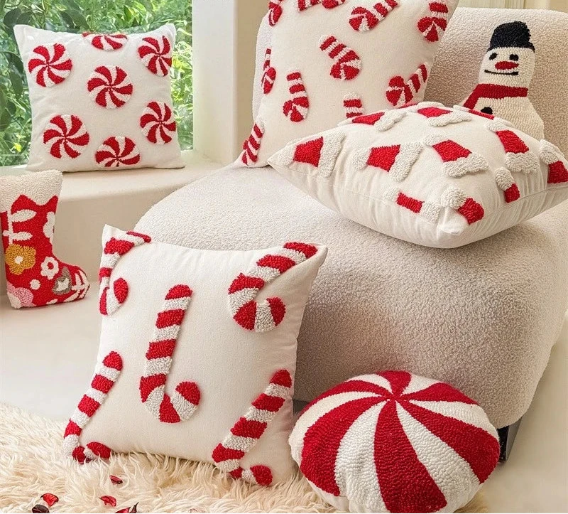 Decorative pillows with candy cane patterns on a couch.