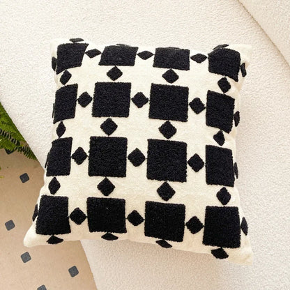 Decorative pillow with black geometric pattern on a light background. Bohemian embroidered throw pillow cover 18x18 inch with geometric towel embroidery, decorative cushion for sofa, bed, or living room boho home decor