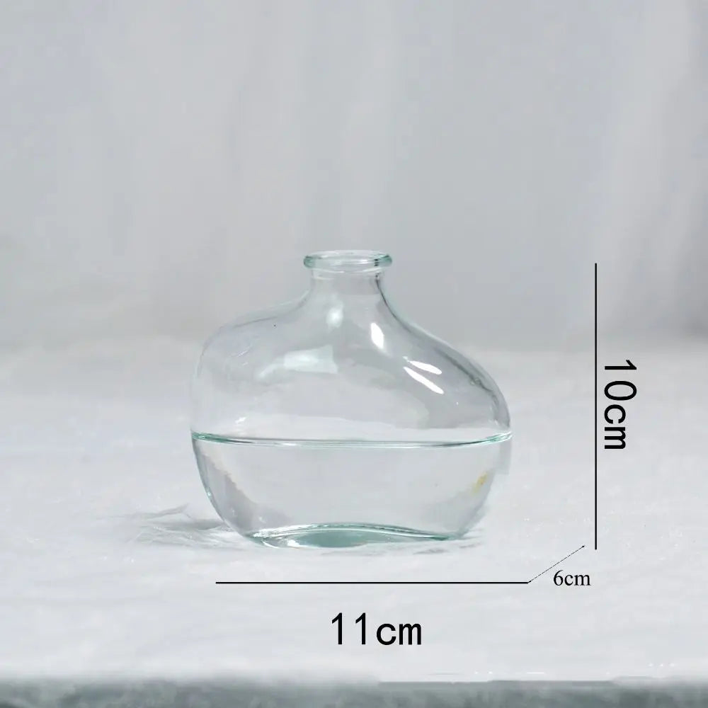 Clear glass vase with dimensions labeled on a light gray background