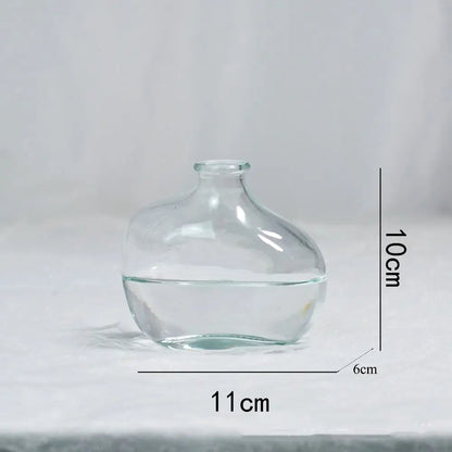 Clear glass vase with dimensions labeled on a light gray background
