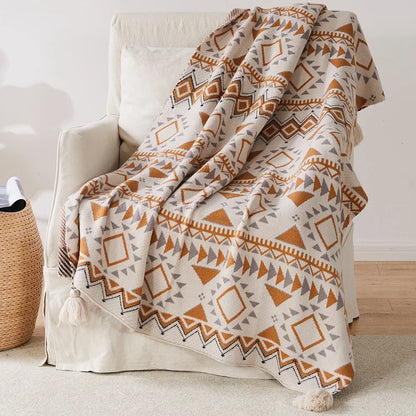 Bohemian Patterned blanket draped over a chair in a room with a woven basket and wooden floor.