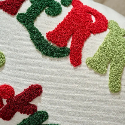 Close-up of a textured surface with red and green shapes resembling letters or abstract forms.