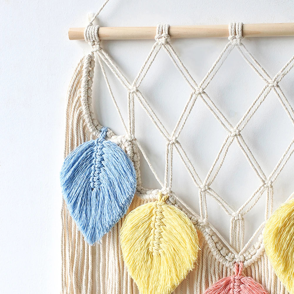 Macrame wall hanging with colorful tassels on a white background