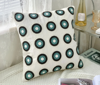 Decorative pillow with circular pattern on a couch, floral embroidery on linen cotton cushion cover – boho home decor accent