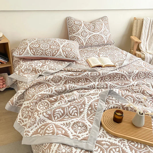Bed with patterned bedding and pillows in a bedroom setting. Boho breathable lightweight summer spring fall blanket quilt bedspread 