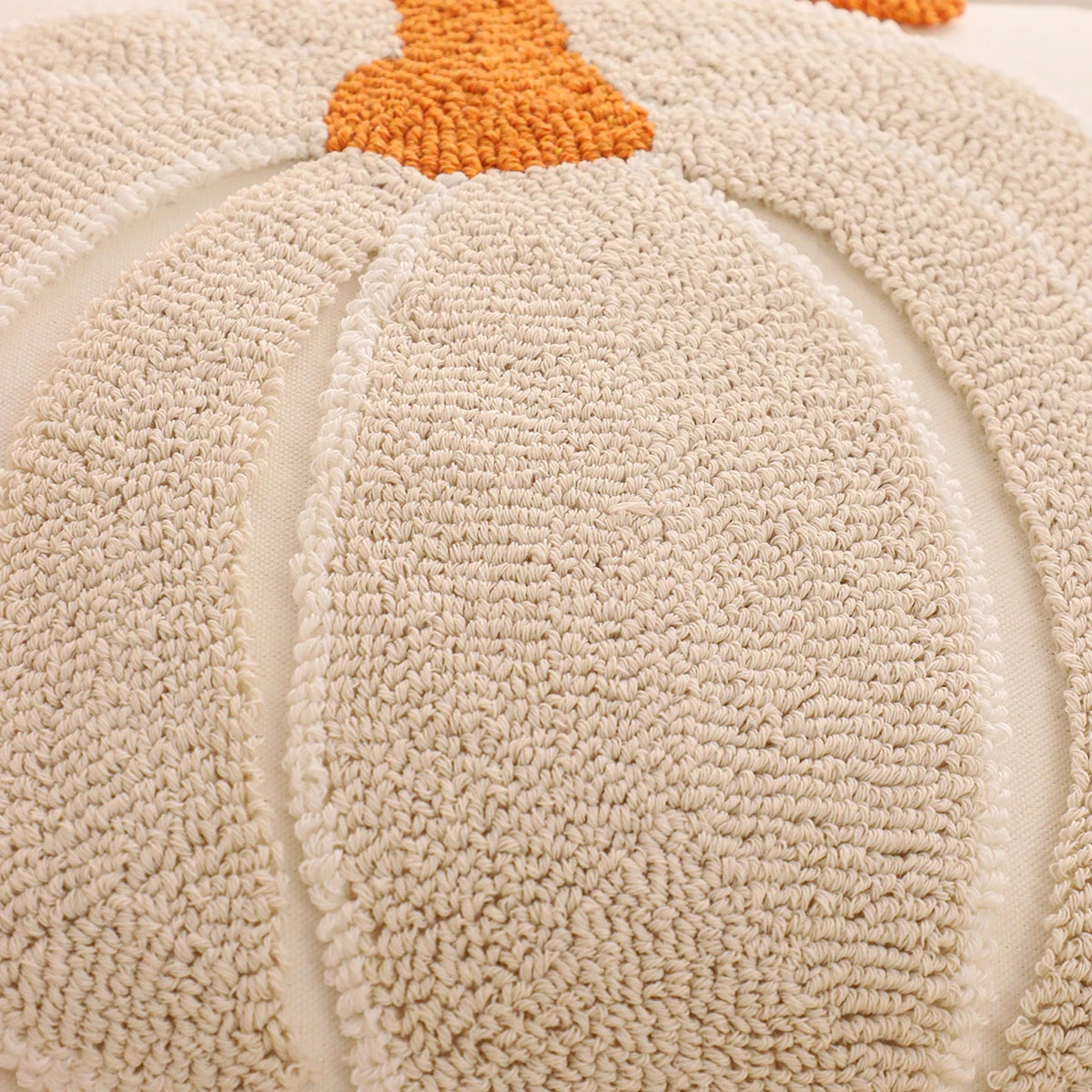 Beige pumpkin-shaped rug with an orange center. Thanksgiving pumpkin throw pillow cover for sofa and bed