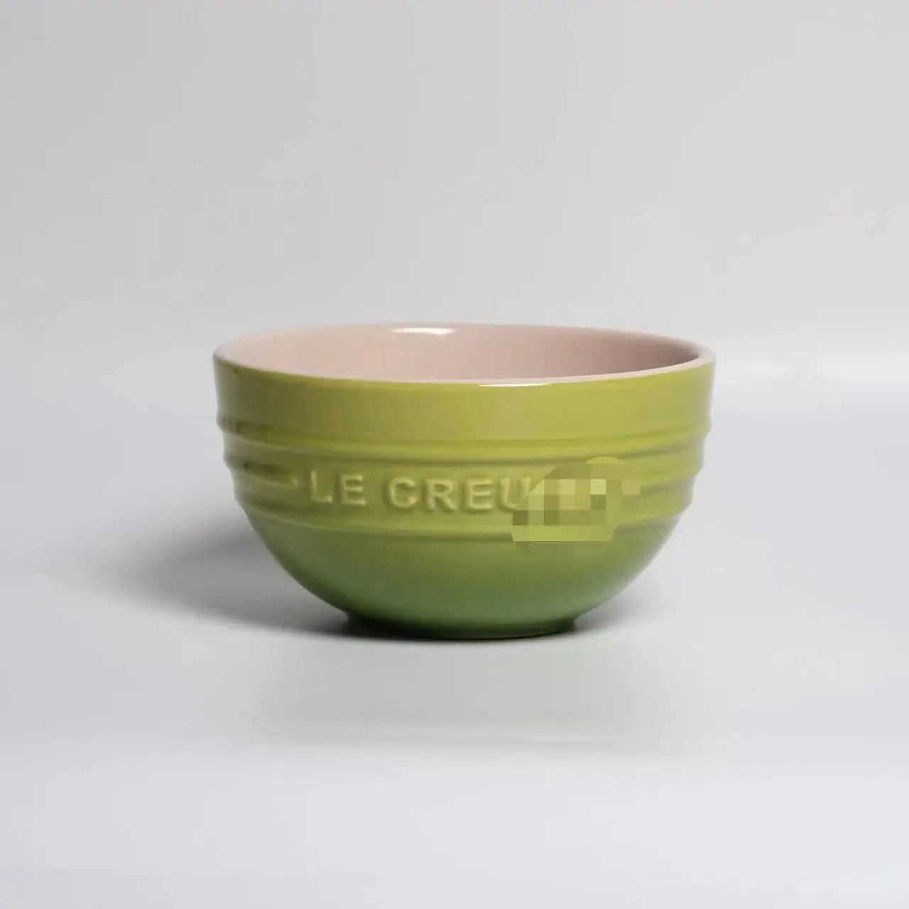 Green mixing bowl with pink interior on a gray background Gradient ceramic rice bowl in bright colors, bone china soup and noodle bowl, dessert and pudding kitchen tableware for boho home dining