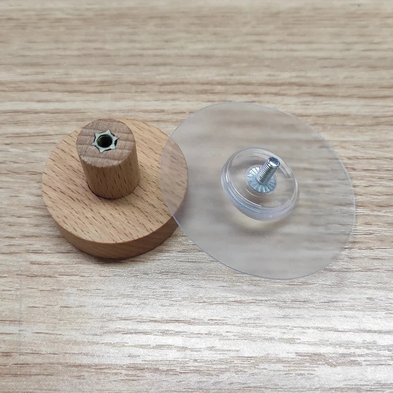 Wooden and clear circular objects with metal screws on a wooden surface. Boho rope toilet paper holder, nail-free wall mounted paper towel rack, rustic bathroom storage and decor accessory with wood and rope design
