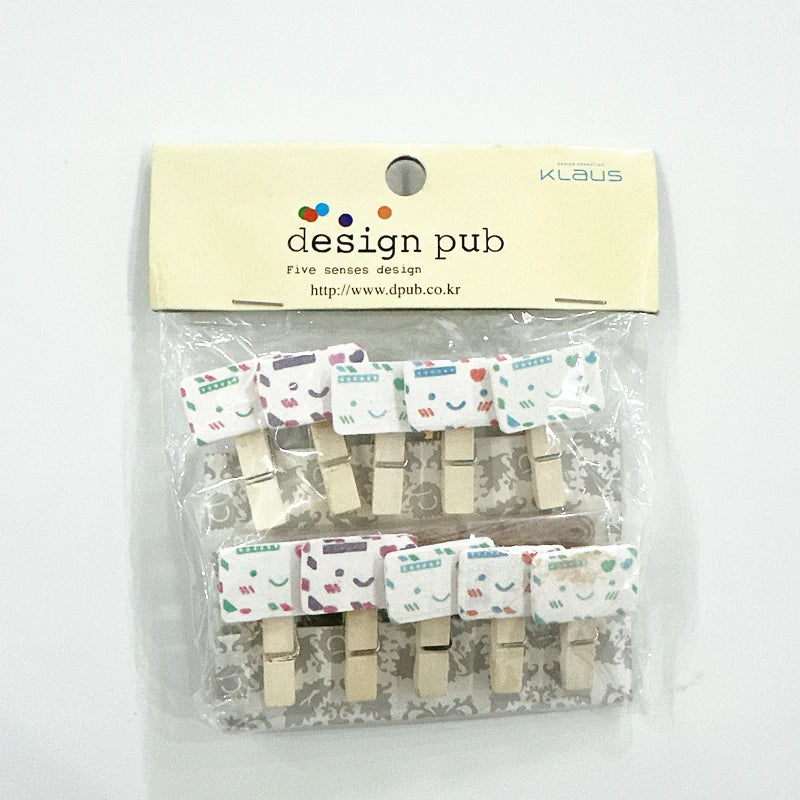 Packaged wooden clothespins with printed labels on a white background