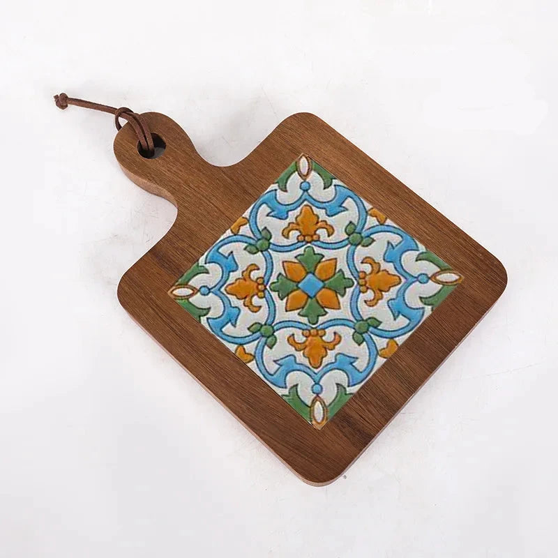 Wooden cutting board with decorative tile design on a white background