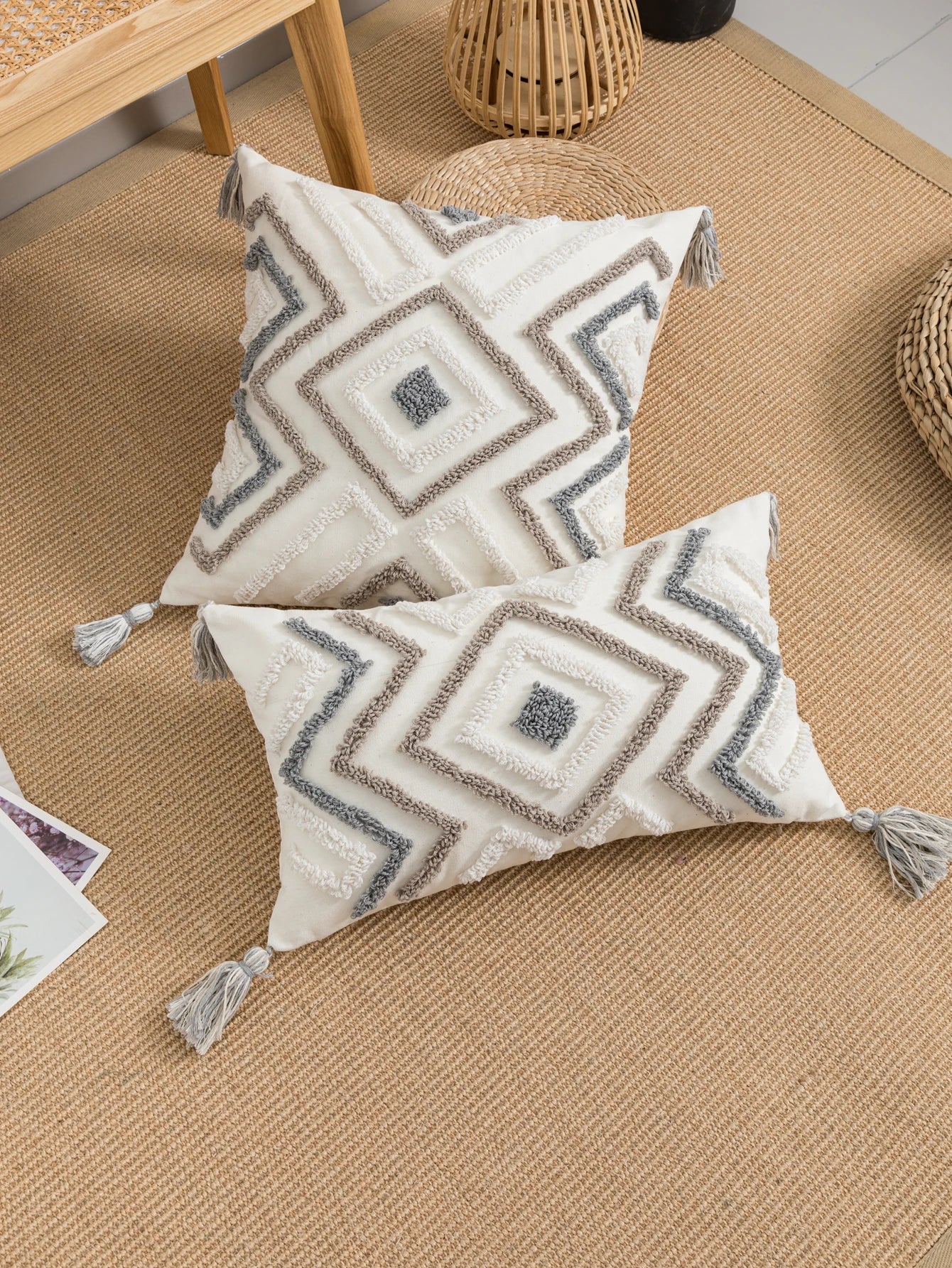 Decorative pillows with geometric patterns on a textured surface