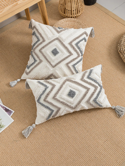 Decorative pillows with geometric patterns on a textured surface