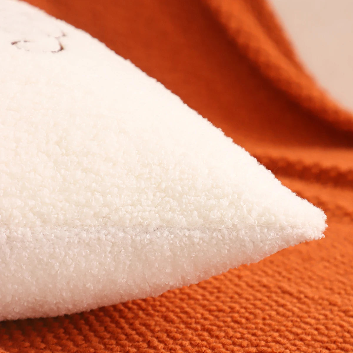 Close-up of white fabric on an orange background. fall boho pillow throw gift ideas