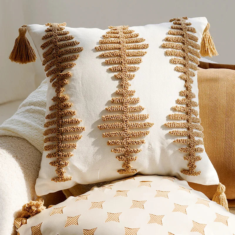 Decorative pillow with tassels on a neutral background