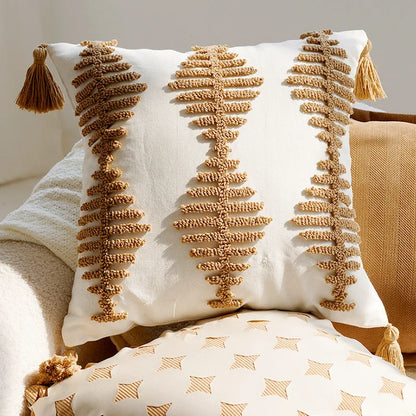 Decorative pillow with tassels on a neutral background