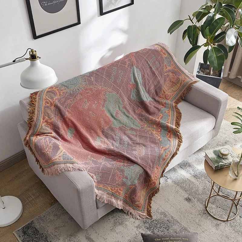 Decorative blanket draped over a chair in a living room setting. Bohemian world map woven blanket cotton sofa throw home decor