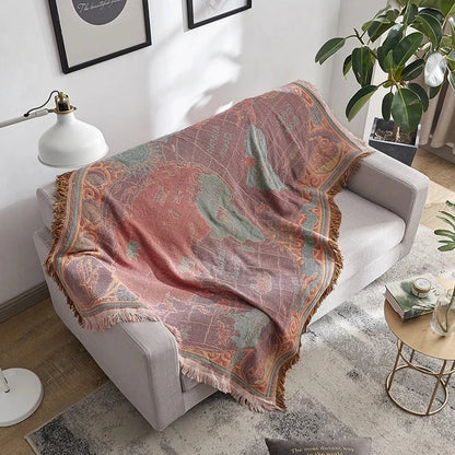 Decorative blanket draped over a chair in a living room setting. Bohemian world map woven blanket cotton sofa throw home decor