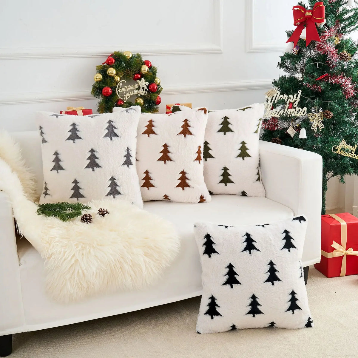 White sofa with Christmas-themed cushions and decorations in a festive living room.