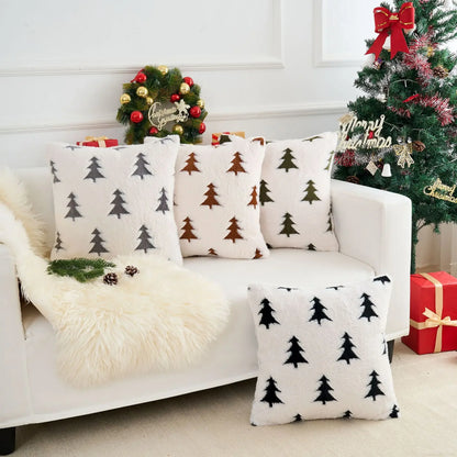 White sofa with Christmas-themed cushions and decorations in a festive living room.
