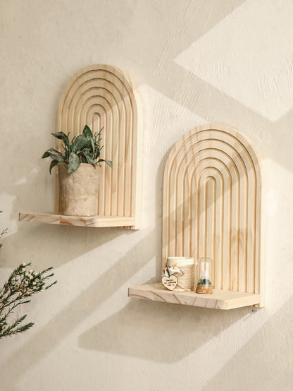 Two wooden arch-shaped shelves against a textured wall.