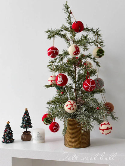 Decorative Christmas tree with ornaments on a white surface