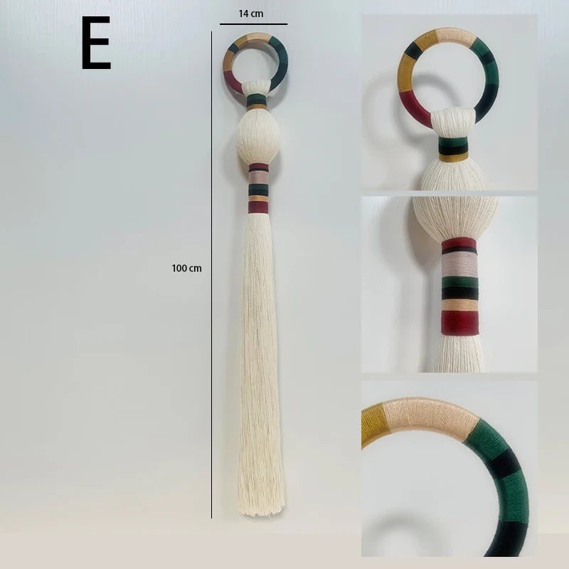 Decorative item with colorful handle and tassel on a white background. boho macrame wall art