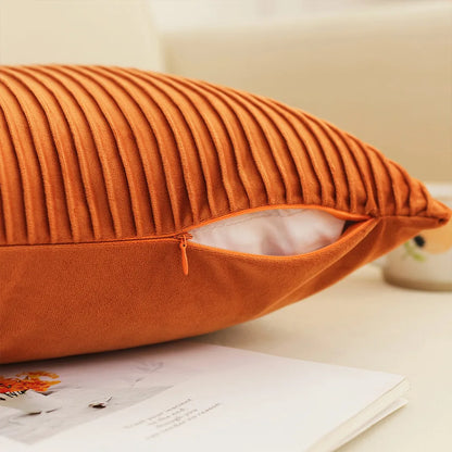 Orange ribbed pillow on a surface with a blurred background. Romantic embroidered French cushion cover 18x18 inch decorative pillow