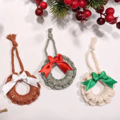 Three woven Christmas ornaments with ribbons on a white background