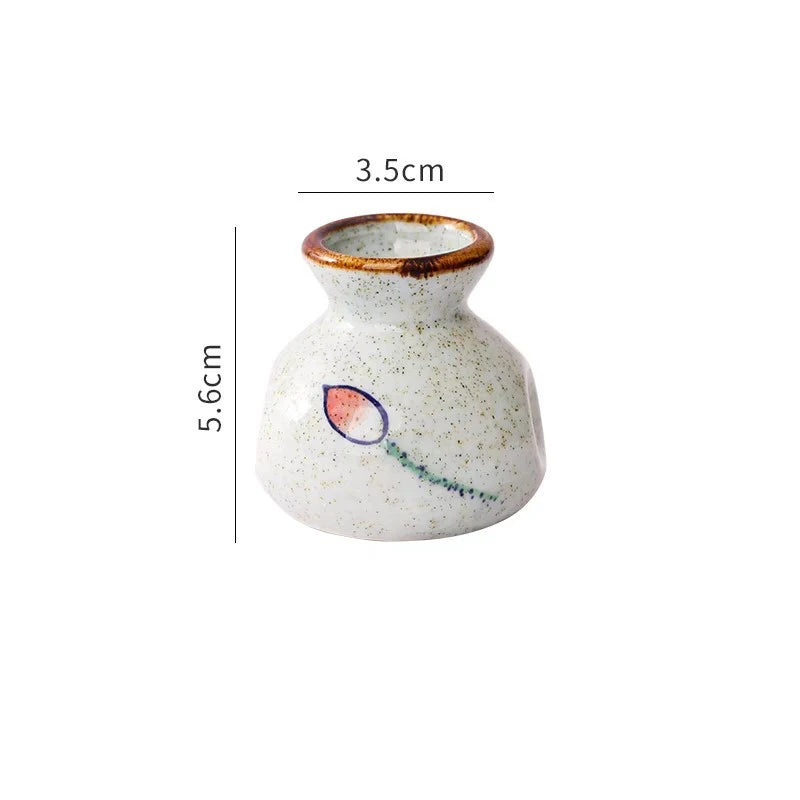 Small ceramic vase with measurements on a white background